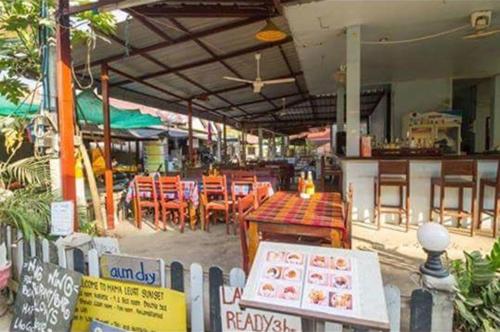 a restaurant with a table and chairs and a tables and chairs at Ning Ning Bungalow in Don Det
