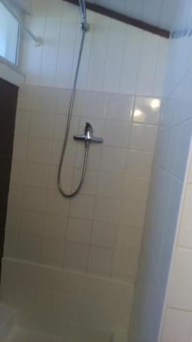 a shower in a bathroom with a hose on the wall at Chambres d'Hôtes de la Grone in Argelès-sur-Mer