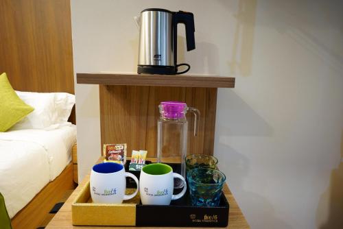 a tray with cups and a coffee maker on a table at five6 Hotel Splendour in Singapore