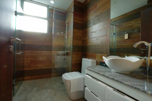 a bathroom with a sink and a toilet and a shower at five6 Hotel Splendour in Singapore