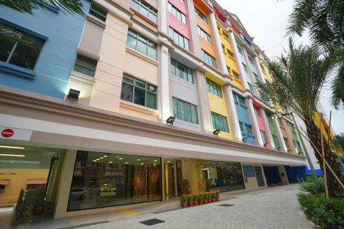 a large building with colorful windows and a palm tree at five6 Hotel Splendour in Singapore