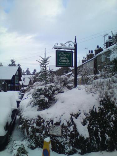 a street sign in the snow on a street at Llugwy Cottage in Betws-y-coed