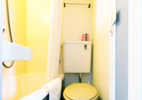 a small bathroom with a toilet and a shower at FLEXSTAY INN Kawasaki Ogawacho in Kawasaki