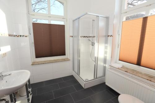 a bathroom with a shower and a sink at Appartementhotel in Stade in Stade