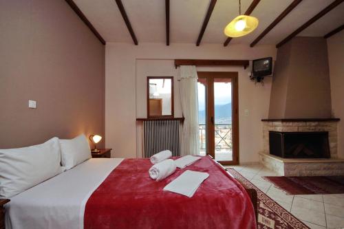 a bedroom with a large bed and a fireplace at Guesthouse Panorama in Vytina