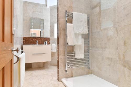 a bathroom with a shower and a sink at Heritage Bed and Breakfast in Calne