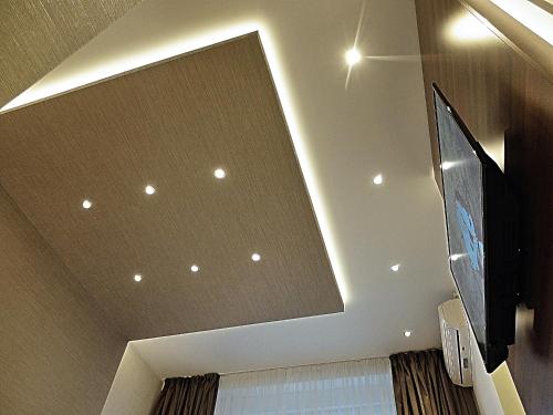 a ceiling with recessed lights and a flat screen tv at Aria Royal Nusic apartment in Belgrade