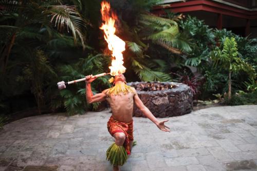 a man with a fire torch on his head at Catamaran Resort Hotel and Spa in San Diego