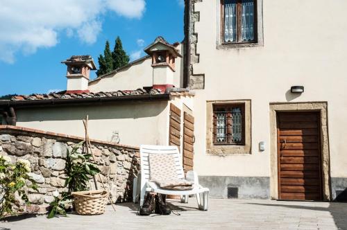a chair on a patio in front of a building at Agriturismo di Baroni Enzo in Dicomano