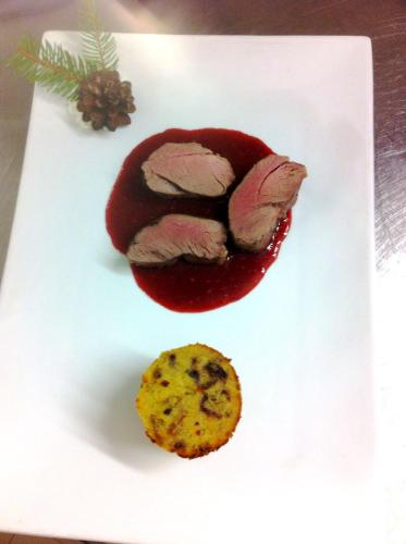 a piece of food on a white plate with a cookie at Hotel Patrizia Dolomites Glamour in Moena