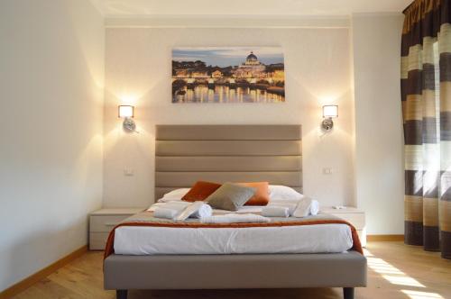 a bedroom with a bed with a painting on the wall at Vatican City Relais in Rome
