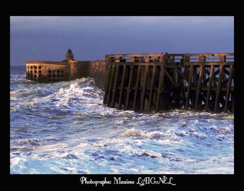 a pier in the middle of the ocean with waves at LE KALEHO, Grand Duplex au coeur de Dieppe - NETFLIX in Dieppe