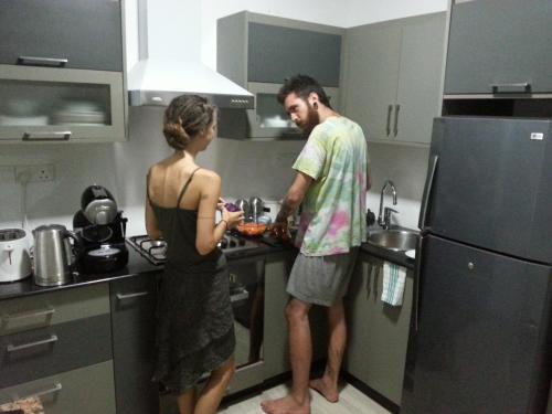 a man and woman in a kitchen preparing food at Mama Beach Villa in Negombo