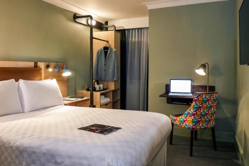 a hotel room with a bed and a laptop on a desk at The Grand Bristol By Sunday in Bristol