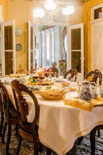 a dining room with a table with food on it at Casa Da Avo - Turismo De Habitacao in Torre de Moncorvo