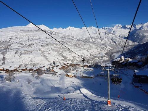 a ski lift going up a snow covered mountain at Luxury Apartment MONTCHAVIN in Montchavin