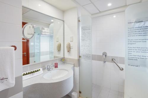a bathroom with a sink and a mirror at Makarem Umm Al Qura Hotel in Makkah
