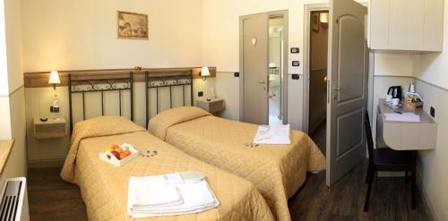 A bed or beds in a room at Albergo Benito