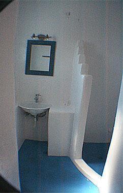 a white bathroom with a sink and a mirror at Villa Sophie in Naousa
