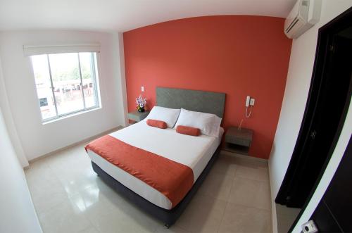 Una cama o camas en una habitación de Hotel Confort Ariari