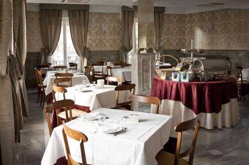 a restaurant with tables and chairs with white table cloth at Da ö Vittorio SRL in Recco
