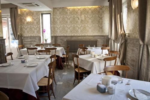 a restaurant with tables and chairs with white table cloth at Da ö Vittorio SRL in Recco