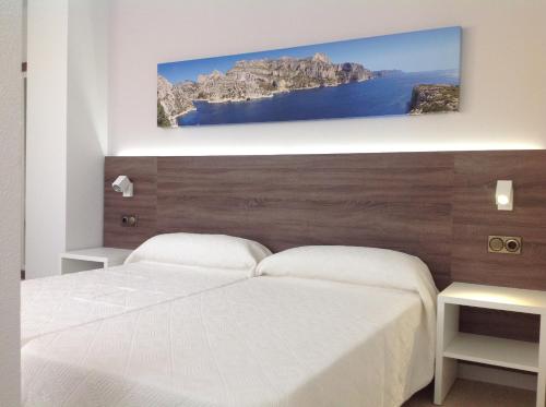 Ένα ή περισσότερα κρεβάτια σε δωμάτιο στο Iberflat Apartamentos Marynton