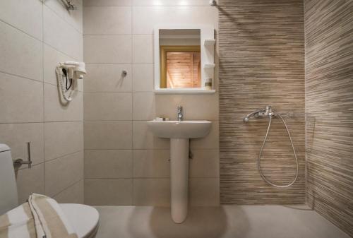 a bathroom with a sink and a toilet and a shower at Athina Apartments Near The Sea Platania in Plataniás
