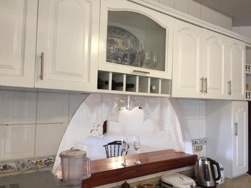 a kitchen with white cabinets and a counter top at Best place in Plaza Mayor Lima, Pizarro building in Lima