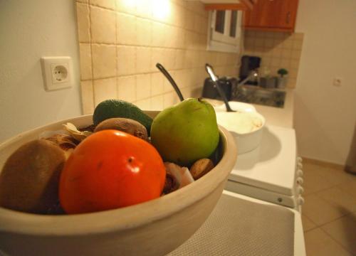 a bowl of fruit on a counter in a kitchen at Echinades Resort in Vasiliki