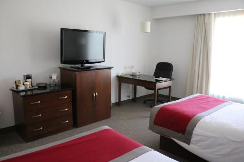 Una cama o camas en una habitación de Radisson Poliforum Plaza Hotel Leon