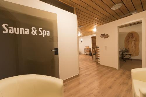 a room with a sign on the side of a wall at RelaxHotel Tannenhof in Sasbachwalden