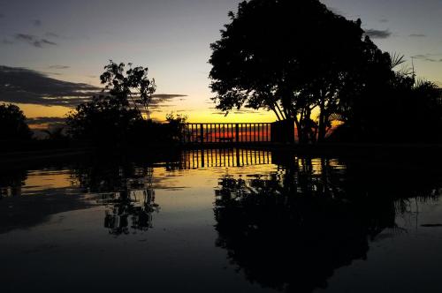 a sunset with a reflection in a body of water at Punta Duarte Garden Inn in Los Duarte