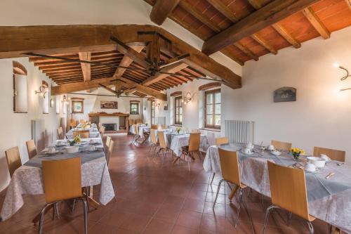 een grote eetkamer met tafels en stoelen bij Poggio Cennina Resort in Bucine