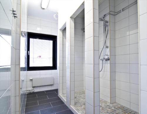 a bathroom with a shower and a television at Hostel 10 in Gothenburg