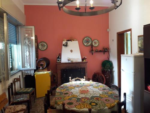 a dining room with a table and a fireplace at Villa Gina in Avola