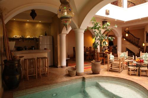 a large room with a swimming pool in a house at Riad L'Emir in Marrakech