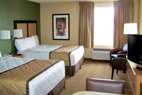 a hotel room with two beds and a television at Extended Stay America Suites - Los Angeles - Glendale in Glendale
