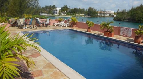 a large swimming pool next to a large body of water at Dundee Bay Villas in Freeport