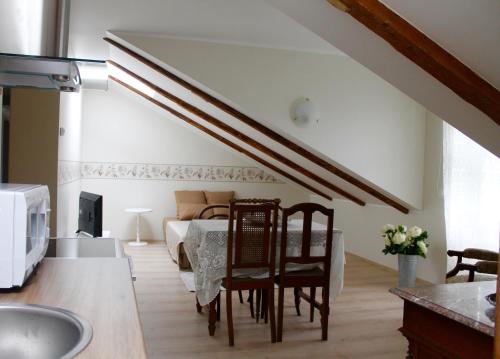 a kitchen with a table and chairs and a bedroom at Austri Villa in Pärnu