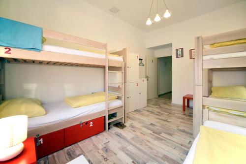 a room with two bunk beds and a hallway at Hostel Temza in Zagreb