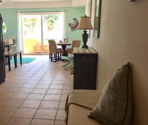 a living room with a couch and a table at Seaside Villas in Caye Caulker
