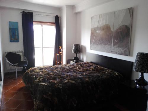 Cama o camas de una habitación en Apartamento Montes e Vales no Centro