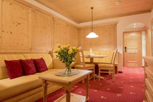 a living room with a couch and a table at Hotel Bergkristall in Silbertal