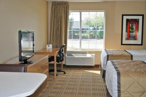 a hotel room with two beds and a desk and a window at Extended Stay America Suites - Los Angeles - Monrovia in Monrovia