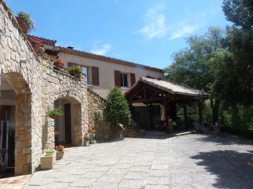 a stone building with a pavilion in front of it at "Le Pigeonnier" chambre d'hôte in Piégros-la-Clastre