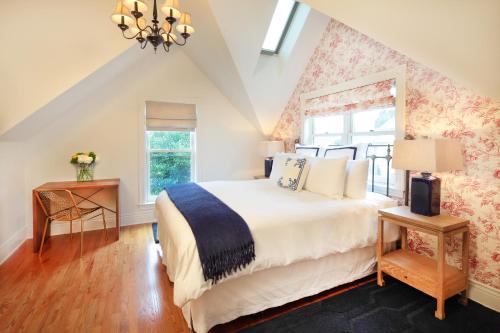 a bedroom with a large bed and a window at The Grape Leaf Inn in Healdsburg