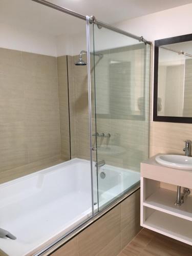 a bathroom with a shower and a tub and a sink at Hotel Villa Blanca in Popayan