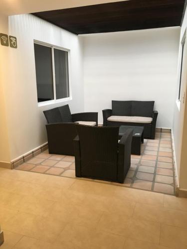 a room with chairs and a table and a table and chairs at Hotel Villa Blanca in Popayan