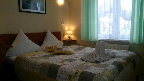 a bedroom with a bed with towels on it at Villa SORENTO in Mielno